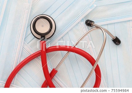 Stethoscope lies on medical protective masks closeup 75594984