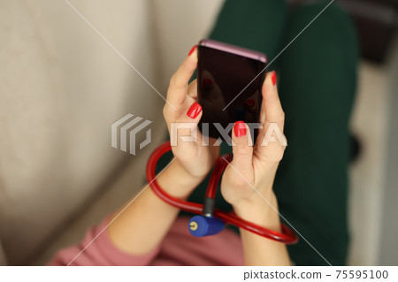 Female hands with lock hold smartphone closeup Female hands with lock hold smartphone closeup 75595100