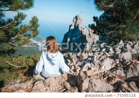 Little kid on edge of cliff in mountains Little kid on edge of cliff in mountains 75595118