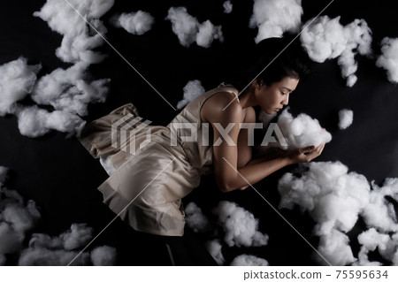 Asian Woman sleep on Scatter Fake Cloud at Night Sky Time Asian Woman sleep on Scatter Fake Cloud at Night Sky Time 75595634