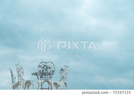 Old chair and cloudy sky 75597155