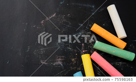 Colored chalk on a blackboard. Blackboard with crayons. The concept of school 75598163