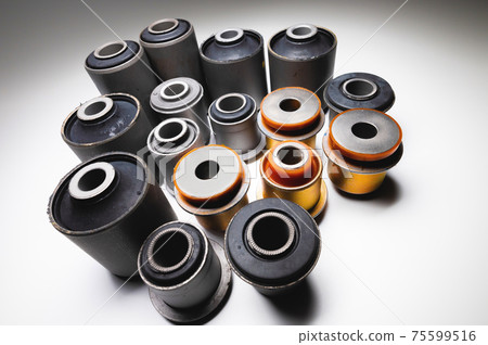 A set of new rubber and polyurethane silent blocks for an SUV on a gradient background. 75599516