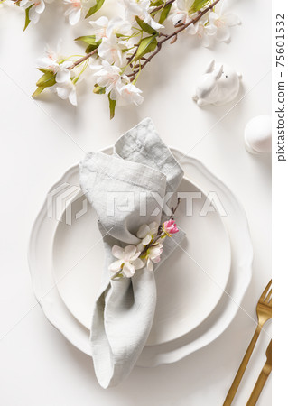 Easter dinner with blossom flowers on white. Easter dinner with blossom flowers on white. 75601532