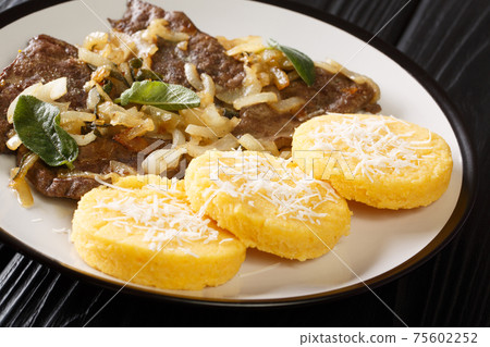 Liver with Onions Sage and Vinegar Fegato Alla Veneziana with polenta closeup in the plate. Horizontal 75602252