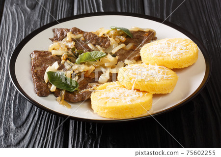 Delicious Fegato alla veneziana recipe a famous and traditional Venetian recipe closeup in the plate. Horizontal Delicious Fegato alla veneziana recipe a famous and traditional Venetian recipe closeup in the plate. Horizontal 75602255