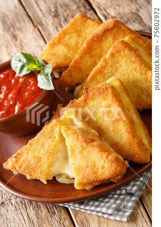 Mozzarella in Carrozza Fried Italian Sandwiches with sauce closeup in the plate. Vertical Mozzarella in Carrozza Fried Italian Sandwiches with sauce closeup in the plate. Vertical 75602972
