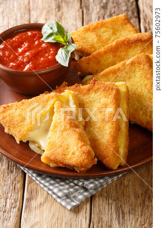 Hot fried sandwiches with mozzarella cheese close-up in a plate. vertical Hot fried sandwiches with mozzarella cheese close-up in a plate. vertical 75602973