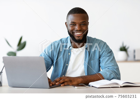 Portrait Of Smiling Successful African American Entrepreneur Posing At Workplace In Office 75603231