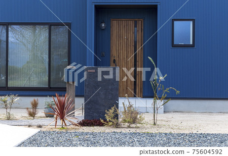 Blue house with a gate pillar Entrance approach 75604592