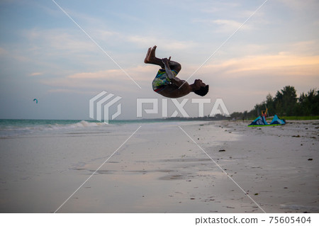 Young Attractive Muscular and Strong Athletic Black African Man at the White Sand Beach Training Body Calisthenics Young Attractive Muscular and Strong Athletic Black African Man at the White Sand Beach Training Body Calisthenics 75605404