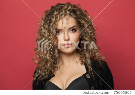 Nice perfect woman with long curly hair on red background.air dye Nice perfect woman with long curly hair on red background.air dye 75605805