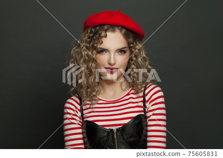Cute young woman wearing french style clothes on black background 75605831