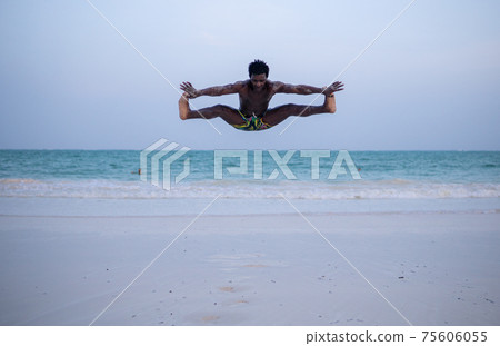 Young Attractive Muscular and Strong Athletic Black African Man at the White Sand Beach Training Body Calisthenics 75606055