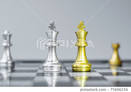 Gold and silver Chess King figure on Chessboard against opponent or enemy. Strategy, Conflict, management, business planning, tactic, politic, communication and leader concept Gold and silver Chess King figure on Chessboard against opponent or enemy. Strategy, Conflict, management, business planning, tactic, politic, communication and leader concept 75606256
