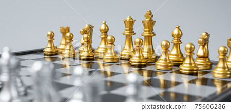 Gold Chess figure team (King, Queen, Bishop, Knight, Rook and Pawn) on Chessboard against opponent during battle. Strategy, Success, management, business planning, think, education and leader concept 75606286