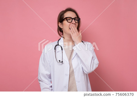 Young beautiful tired doctor woman wearing stethoscope and glasses over blue background Young beautiful tired doctor woman wearing stethoscope and glasses over blue background 75606370
