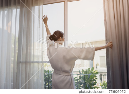 Traveller beautiful asian woman smile to look over there stay near the door in hotel room Traveller beautiful asian woman smile to look over there stay near the door in hotel room 75606952