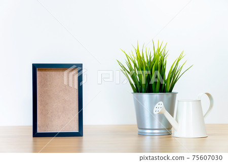 black square frames and green plant on wooden table, black square frames and green plant on wooden table, 75607030