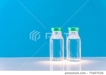 Potential trials stage concept on blue background. Close up Vials with sterile needle syringe. Research and Development, Vaccination. 75607036