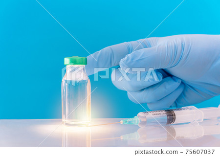 Potential trials stage concept on blue background. Close up Vials with sterile needle syringe. Research and Development, Vaccination. Potential trials stage concept on blue background. Close up Vials with sterile needle syringe. Research and Development, Vaccination. 75607037