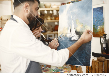 Mixed couple painting in a class Mixed couple painting in a class 75607487