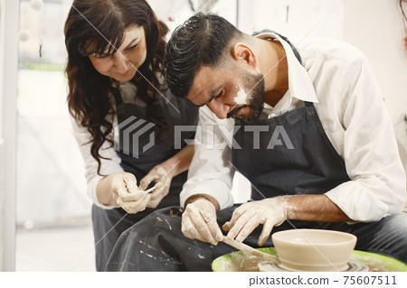 Adult mixed couple at artwork in pottery 75607511
