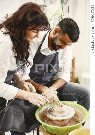 Adult mixed couple at artwork in pottery Adult mixed couple at artwork in pottery 75607535