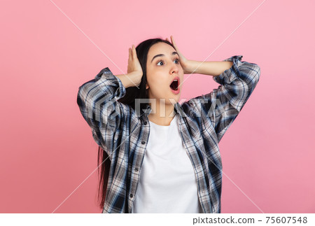 Caucasian woman's portrait isolated on coral pink studio background with copyspace Caucasian woman's portrait isolated on coral pink studio background with copyspace 75607548