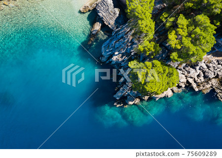 Mediterranean sea. Aerial view on water and rocks during sunset. Vacation and adventure. Mediterranean sea. Aerial view on water and rocks during sunset. Vacation and adventure. 75609289