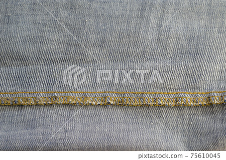 Wrong side of jeans fabric. Detailed shot of the classic yellow threaded fabric. Copy space Wrong side of jeans fabric. Detailed shot of the classic yellow threaded fabric. Copy space 75610045