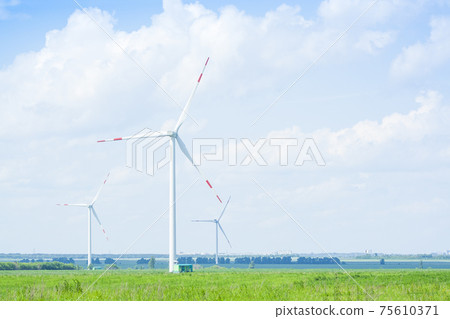 many windmills stand on a large field many windmills stand on a large field 75610371