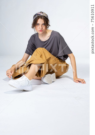 Young white girl on light grey Young white girl on light grey 75610911