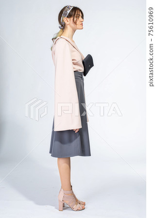 Young white woman isolated on light grey 75610969