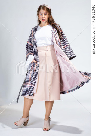 Young white woman isolated on light grey Young white woman isolated on light grey 75611046