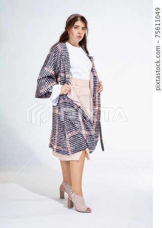 Young white woman isolated on light grey 75611049