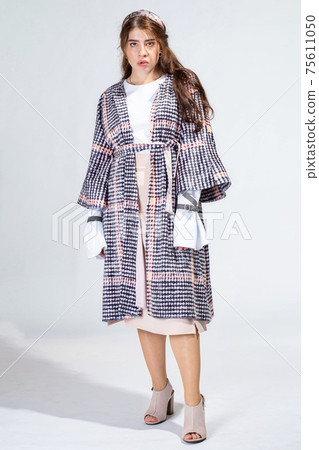 Young white woman isolated on light grey 75611050