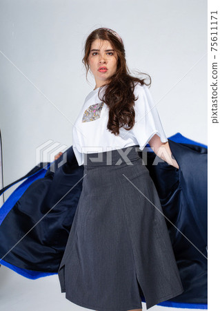 Young white girl on light grey 75611171