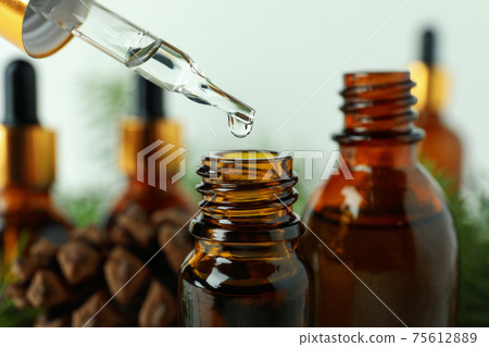 Pipette and bottles with pine oil, close up 75612889