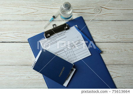 Concept of vaccination with COVID - 19 vaccine on white wooden background 75613664