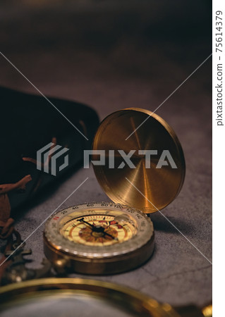 compass, book, and magnifying glass 75614379