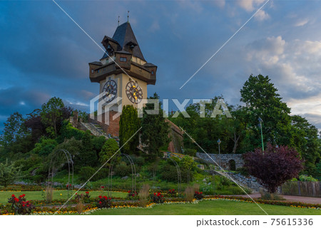 The famous clock tower (Grazer Uhrturm) and gardens on Shlossberg hill, Graz, Styria region, Austria 75615336
