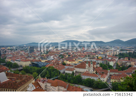 Cityscape of Graz with Mur river and Mariahilfer church (Mariahilferkirche), view from the Shlossberg hill, in Graz, Styria region, Austria Cityscape of Graz with Mur river and Mariahilfer church (Mariahilferkirche), view from the Shlossberg hill, in Graz, Styria region, Austria 75615342