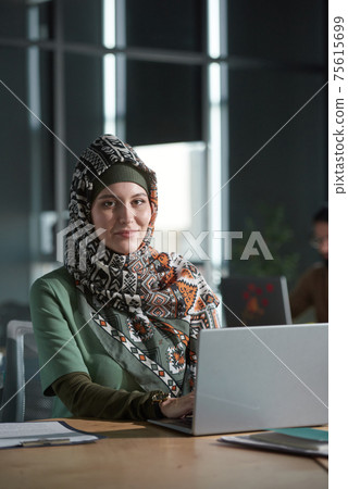 Muslim woman working at office Muslim woman working at office 75615699