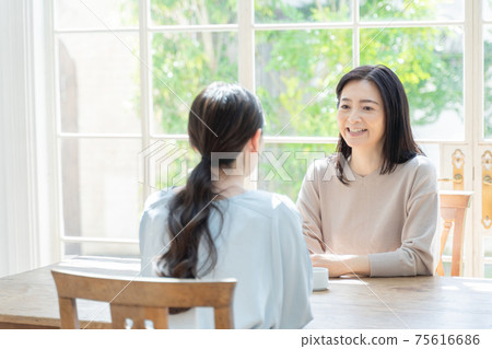Parent and child chatting in the living room Parent and child chatting in the living room 75616686