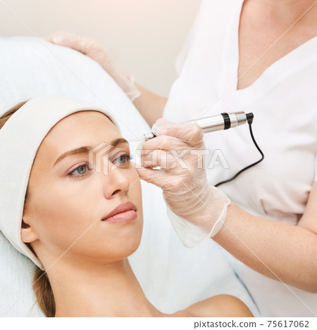 Permanent makeup. Beauty spa procedure. Young woman. Face tattoo Permanent makeup. Beauty spa procedure. Young woman. Face tattoo 75617062