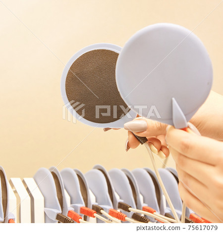 aesthetic salon spa procedure. adjustment. anti cellulite treatment device setting. electrostimulation woman body machine setup 75617079
