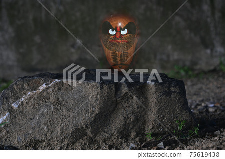 Daruma doll on the stone 75619438