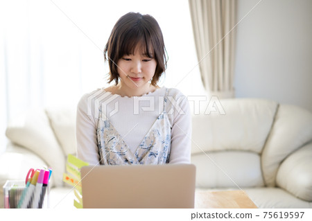 一個在家工作的年輕女子 一個在家工作的年輕女子 75619597