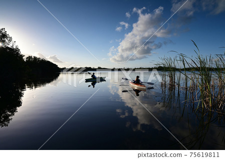 Woman and active senior kayaking on Nine Mile Pond in Everglades National Park. Woman and active senior kayaking on Nine Mile Pond in Everglades National Park. 75619811